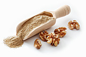 Walnut flour on a wooden scoop