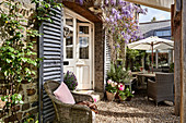 Vintage French shutters and wicker armchairs on terrace