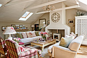 Fireplace, sofas and armchairs in attic living room