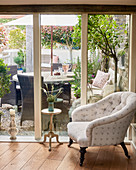 Armchair and side table next to terrace doors