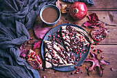 Crepes with melted dark chocolate drizzle and pomegranate seeds