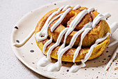 Homemade pumpkin cinnamon bun roll sweet autumn baked dessert with cream cheese sauce