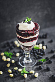 A layered dessert with mulberries and quark