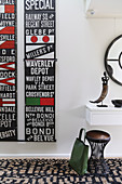 Picture with street signs next to a console table with ethnic decorations