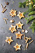 Homemade Christmas New year star shape sugar caramel cookies with frosting and orange citrus jam, cinnamon sticks and anise