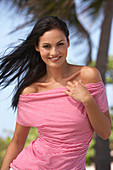 A young brunette woman wearing a red-and-white striped top