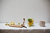 Ingredients for salted lemons (cinnamon, salt, bay leaves, peppercorns) on a light linen cloth