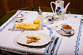 Pancakes with powdered sugar on a 70s style laid table