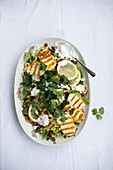 Bulgur salad with grilled halloumi, pomegranate seeds, celery, parsley and a yoghurt dip