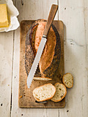 Poppy Seed loaf sliced with butter and knife