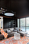 Living room with black walls and high ceilings