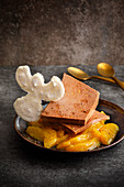 Gingerbread parfait on sliced fruit with a snow angel