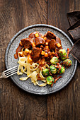 Boar and pear ragout with brussels sprouts and tagliatelle