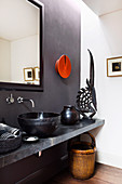 Ethnic style bathroom with gray wall and black decoration