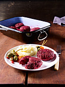 Beetroot beefsteaks with mixed pickles and mashed potatoes