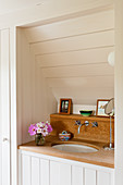 Oak washstand in wood-panelled alcove