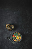 Colourful vegetable and white bean soup on dark background