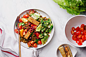 Vegetarian lentil salad with fried cheese, greens and fresh vegeables