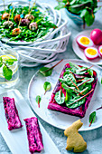 Easter terrine with beetroot and goat cheese, chicken eggs, painted beet juice, quail eggs