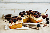 Sliced blackberry cake with mascarpone cream and chocolate