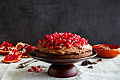 Homemade chocolate cake with mascarpone cream and fresh pomegranate