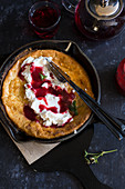 Dutch baby with ricotta and raspberry sauce
