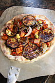 Eggplant pizza with mushrooms, olives, red pepper, red onion and roasted carrot topping