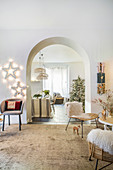 Festively decorated living room with open archway leading into dining room