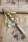 Mini potato dumplings with roast onions on a carving fork