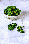 Chips from cabbage kale leaves in a crafting bowl. Healthy food. Vegetarian food