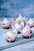 Chocolate cupcakes in pink tulip forms with butter cream