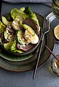 Avocado salad with goose meat and eggs