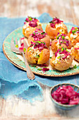 Baked potatoes stuffed with cream cheese and caramelized red onion