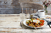 Vegetarian English breakfast (baked beans, roast potatoes, tomatoes, a poached egg)
