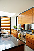 Elegant kitchenette with walnut fronts and kitchen island