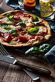 Pizza Margherita with fresh cherry tomatoes, basil and mozzarella