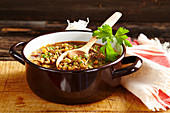 Classic lentil stew with plate lentils, vegetables and bacon