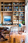 Bookshelf with library manager, globe and round table with chess in the study