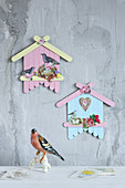 Birdhouse decorations made from painted lolly sticks and scrapbook pictures