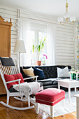 Rocking chair with footstool in rustic living room