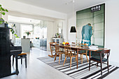 Dining table on striped rug in open-plan kitchen