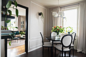Medallion chairs in dining room with grey panelled walls