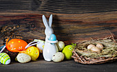 Easter card concept with easter eggs and bunny on wooden rustic background