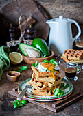 Savory waffles with mashed avocado and fried eggs