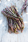 Fresh violet asparagus on a wooden table