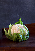 A cauliflower on a wooden background