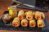 Pigs in blankets with sesame seeds
