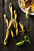 Basil and parmesan breadsticks with hummus dip