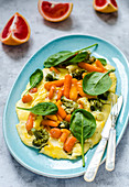 Omelet with broccoli, baby carrots, cheese and spinach