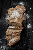 A long loaf of flax seed wholemeal bread, sliced